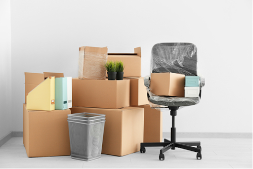 Boxes next to an office chair.