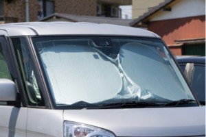 Car with its windshield covered.