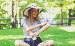 Woman applying sunscreen.