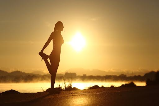 Woman stretching outside.