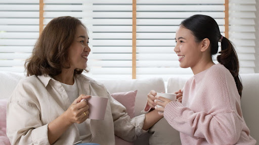 Mother and daughter drinking coffee.