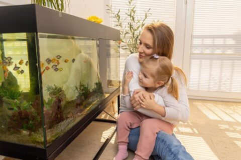 Woman next to a fish tank