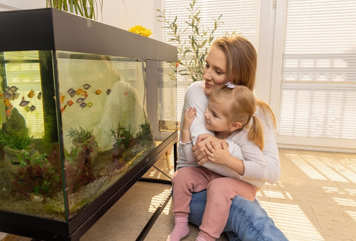 Woman next to a fish tank