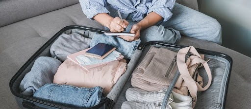 Person packing suitcase.