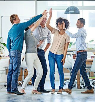 A group of employees share a collective high-five.