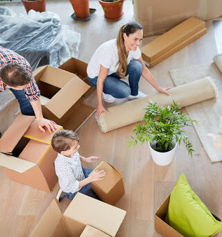 A family packs up the living room of their house.