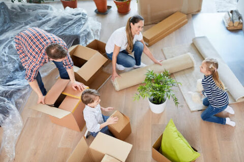 A family packs up the living room of their house.