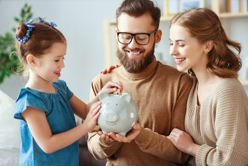 Family holding a piggy bank.